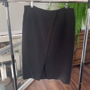 Black pencil skirt with front detail and front slit.